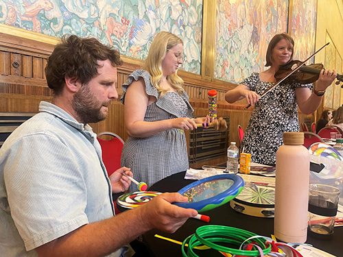 Three adults with musical instruments